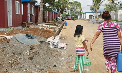 Woman and girl carrying water in the Philippines